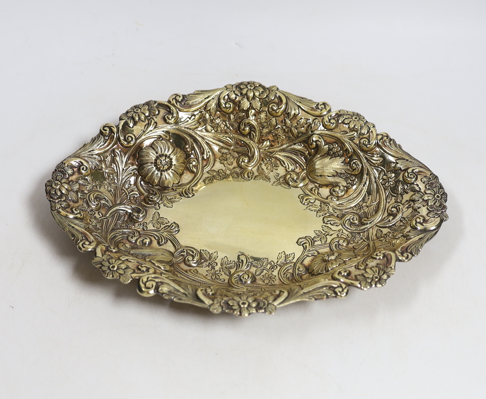 A late Victorian embossed silver gilt oval dish, by Charles Stuart Harris, London, 1886, 27cm, 8.2oz.